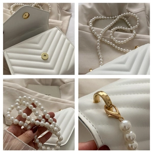 Detail of white V-quilted faux leather bag with pearl chain and golden hardware