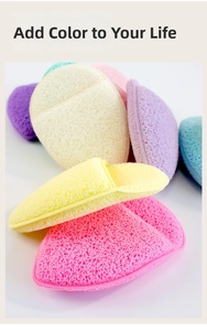 Close-up of colorful facial cleansing sponges with porous texture and finger pocket