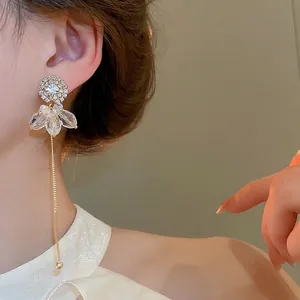 Elegant gold drop tassel earrings with sparkling rhinestones and flower petal design