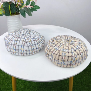 Detailed texture of colorful plaid tweed beret hats with retro octagonal design