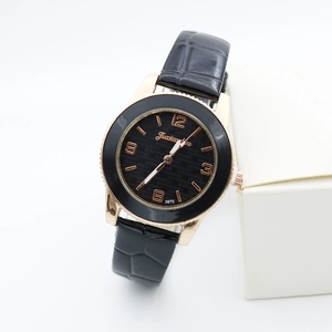 Detail of quartz watch with black textured dial, rose gold case, and crocodile leather strap