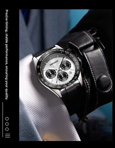 Close-up of a silver multi-function dial watch with tachymeter on a businessman's wrist