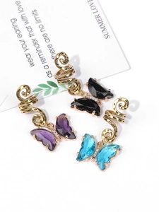 Detail of butterfly crystal hair clips with vintage gold spiral rings on decorative card