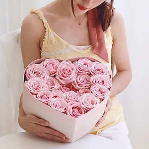 Pink heart-shaped gift box filled with fresh roses for Valentine's Day surprise