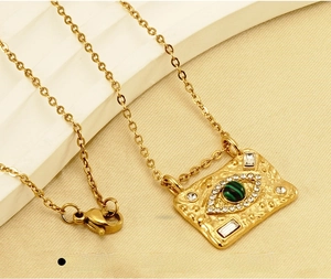 Detail of 18K gold plated stainless steel necklace with malachite evil eye pendant