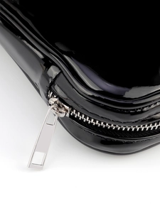 Detail of glossy black PU makeup brush bag featuring a silver metal zipper closure
