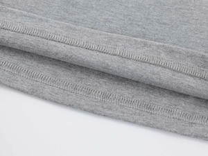 Macro detail of high-quality double-needle stitching on gray modal t-shirt hem