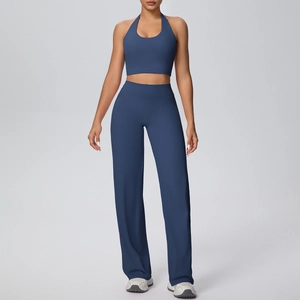 Detail of high-waisted navy yoga set showing wide-leg pants and halter neck sports top