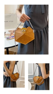 Detail showing orange geometric handbag with embossed pattern and silver chain strap