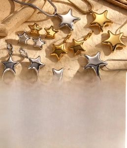 Detailed view of star-shaped titanium steel jewelry in gold and silver finishes