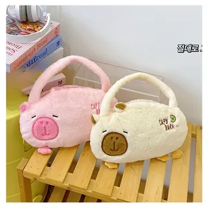 Detail of cute plush Capybara handbag in pink and cream colors with embroidery