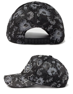 Detail view of floral embroidery and rhinestone accents on a black lace mesh sun hat