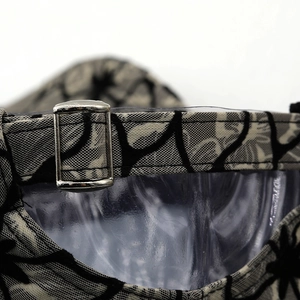 Detail view of the floral baseball cap adjustable metal buckle and woven strap texture