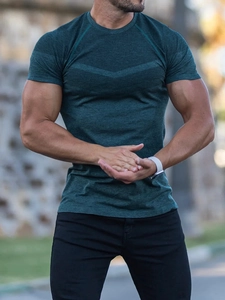 Close-up of men's dark green athletic T-shirt featuring breathable mesh panels and texture