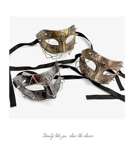 Detailed view of vintage punk half masks with gold spikes, metal chains, and silk ribbons