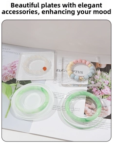 Detail view of wood bead bracelets and jade bangles on clear acrylic display trays