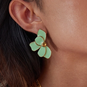 Fashionable mint green flower petal earring in stainless steel shown on a model's ear
