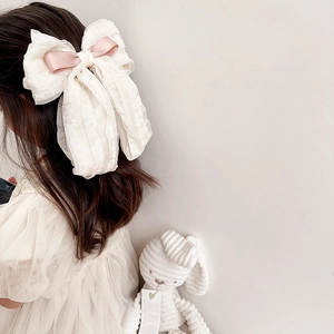 French retro beige chiffon bow hair clip with pink satin ribbon on a little girl