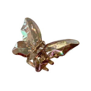 Iridescent butterfly hair claw clip with aurora resin finish on white background
