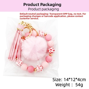 Detail of pink silicone bead bracelet with faux fur pompom and tassel in OPP packaging