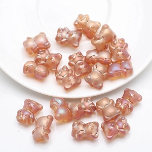 Macro detail of iridescent 3D bear charms with rainbow finish for DIY jewelry