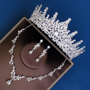 Detailed view of silver bridal jewelry set with sparkling rhinestones and crown