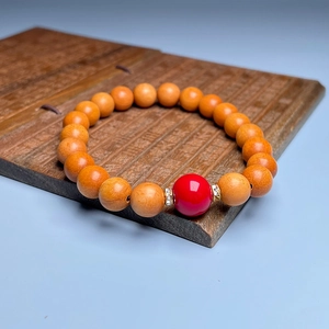 Zen style sandalwood bead bracelet with red bead and crystal spacers on wooden script