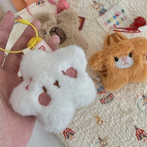 Detail of plush animal charms with fine embroidery on soft cream circus blanket