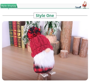 Detail of Christmas plush gnome on wooden skis with red knit hat and Nordic winter decor