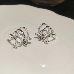Close-up of sparkling silver butterfly multi-layer ear cuff with zircon micro-paving