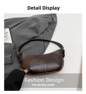 Detail view showing textured dark brown leather and stitching on the tote bag