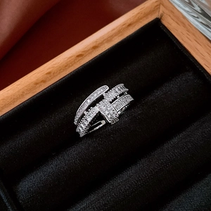 Macro shot of silver ring with pave-set cubic zirconia on black velvet background