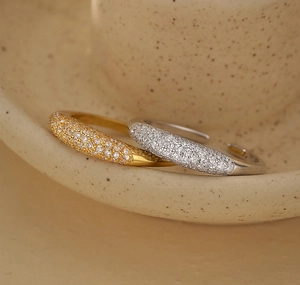 Detailed close-up of gold and silver pave set adjustable rings with sparkling zircons