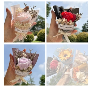 Detail showing four mini soap flower bouquets with roses and sunflowers in gift wrap