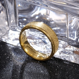 Macro detail of 6mm matte gold titanium steel ring with smooth inner surface on black