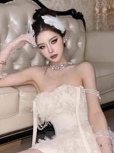 Detail of white swan feather hair clip and lace hair accessories on an elegant model