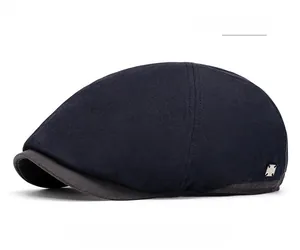 Detail of navy blue newsboy hat with canvas texture and metal side buckle ornament