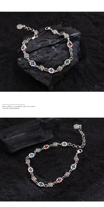Detailed macro view of S925 silver gothic bracelet with cross and rose motifs