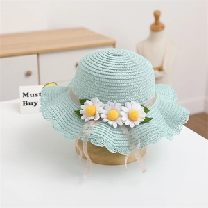 Detail of baby straw hat with white daisies and mint blue wavy lace brim design