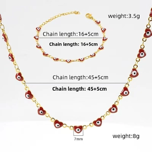 Detail of 18K gold-plated necklace and bracelet set with red heart evil eye charms