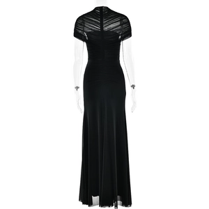 Detail of elegant black pleated evening dress with sheer mesh capelet on professional model