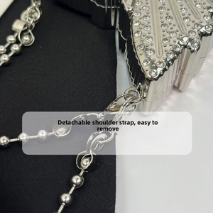 Detail of detachable metal chain strap with lobster clasp on rhinestone evening bag