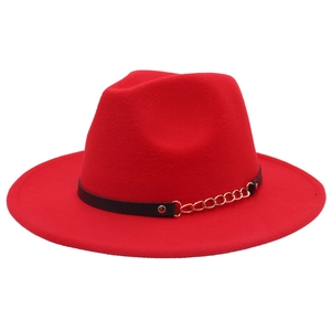 Detail view of red fedora hat with black leather strap and gold metal chain link