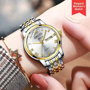 Detail of ORUSS quartz watch with two-tone steel bracelet and date-day display on wrist