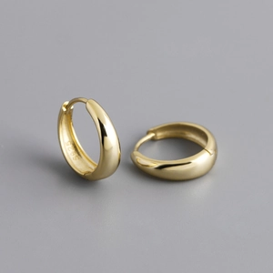 Macro shot of polished S925 sterling silver hoop earrings with a mirror finish
