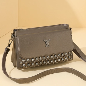 Metallic grey faux leather crossbody bag with rhinestone studs and rabbit logo detail