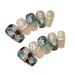 Handmade Christmas press-on nails with burgundy, green and snowflake marble design