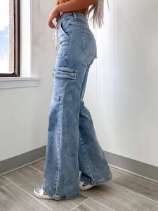 High-waisted wide-leg denim cargo pants in light blue featuring large side flap pockets