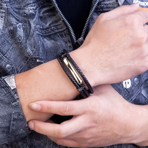 Men's multilayer braided leather bracelet with black and gold metal clasp worn on wrist