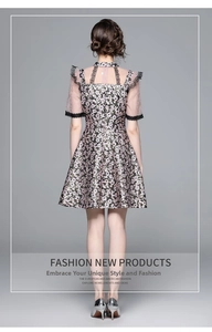 Detail view of pink floral dress back with intricate jacquard texture and lace trim